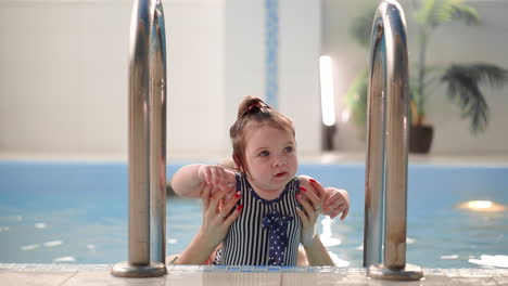 The-cute-baby-getting-out-from-the-swimming-pool