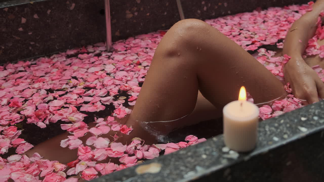 Woman Relaxing in a Rose Petal Bath