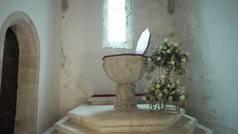 ornate stone pulpit with floral decor inside a historic church interior