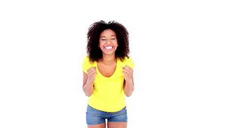 Pretty-girl-in-yellow-tshirt-and-denim-hot-pants-cheering-at-camera