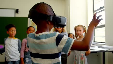 schoolboy using virtual reality headset in classroom at school 4k