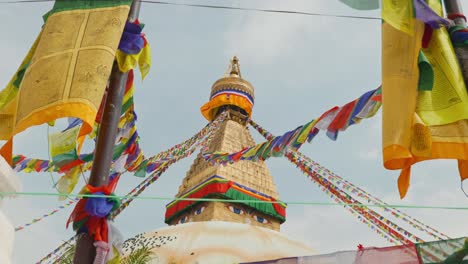 Tilting-clip-of-strings-of-multicoloured-prayer-flags-at-sacred-Buddhist-temple-in-Nepal