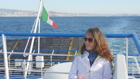 woman sitting on the deck of the ferry boat