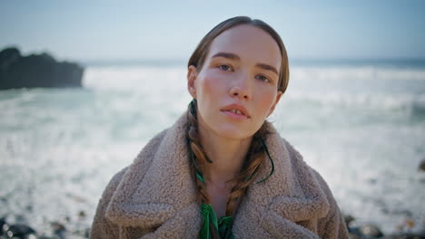 portrait calm woman posing sunny shore. fashion model with braids resting ocean