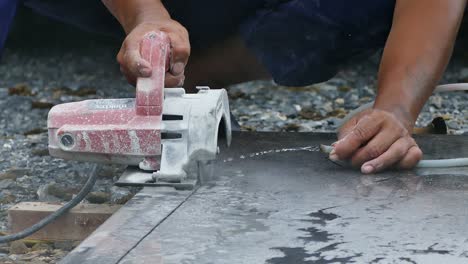 man cutting granite stone