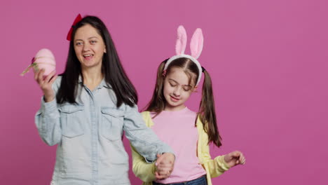 Cute-mother-and-daughter-dancing-around-in-the-studio