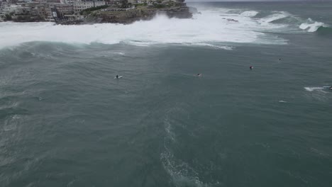 Surfers-Riding-Big-Waves-In-Bondi-Beach-On-A-Stormy-Day-In-Sydney,-NSW,-Australia