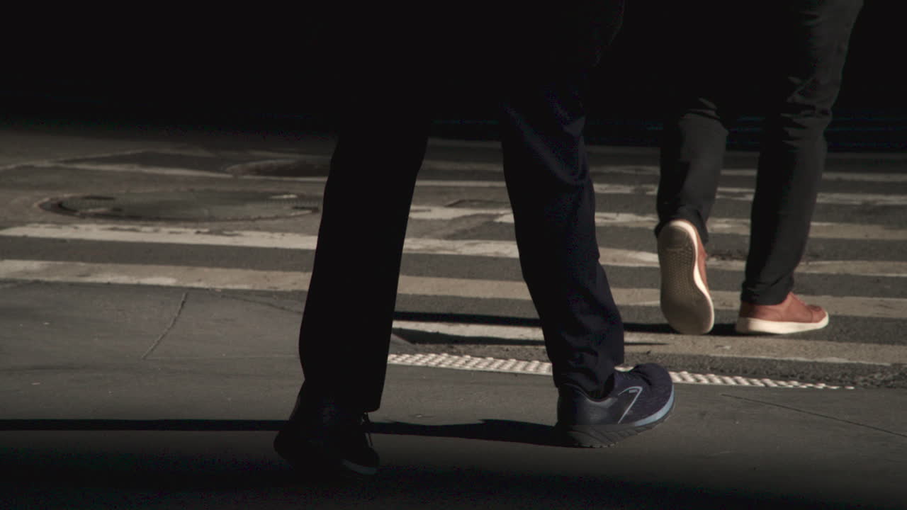 Slow motion shot of feet in a city crosswalk. Shot at sunrise in Manhattan
