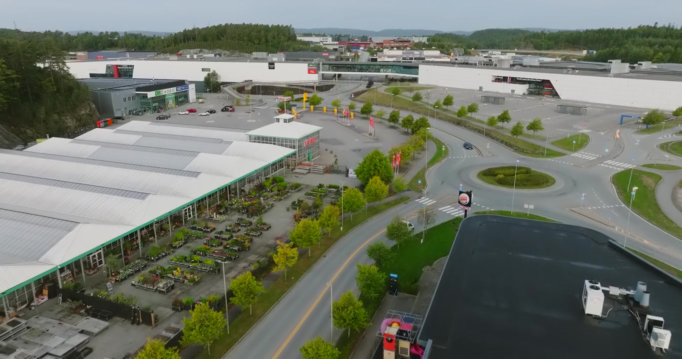 Aerial view of Sørlandsparken commercial district in Kristiansand Norway in slow motion showing wide shot outdoor shopping and commercial building