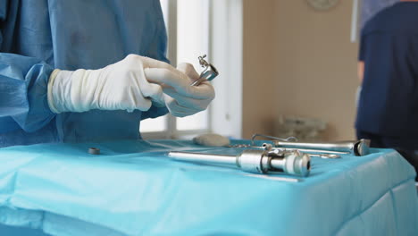 surgeon preparing surgical instruments