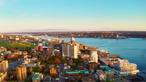 sunrise aerial drone shot over halifax downtown, nova scotia, canada.
high view of the golden landscape and sea at down as the sun is rising in the early morning.