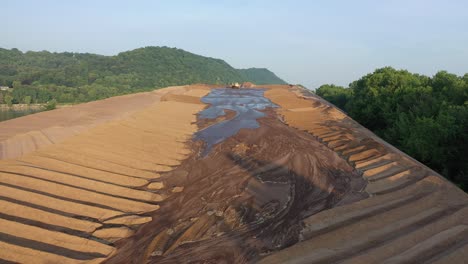 aerial view of construction site with bulldozer and excavation