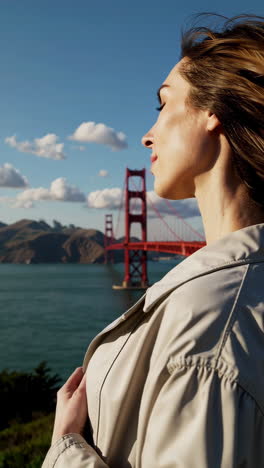 woman admiring the golden gate bridge view in san francisco