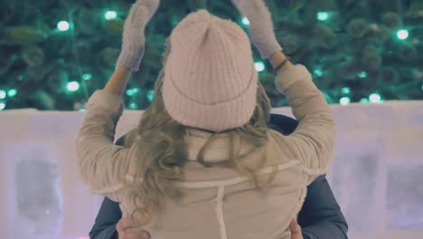 motion around lovely couple kissing at christmas tree