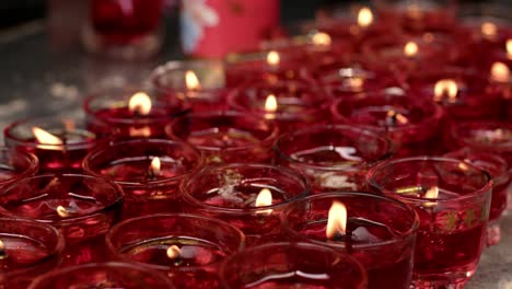 Closeup-of-burning-candles-at-an-ancient-Jade-Emperor-Pagoda-Buddhist-temple-in-Ho-Chi-Minh-City,-Vietnam