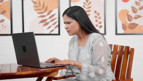 stressed woman working on laptop