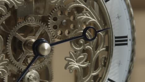 closeup shot of ornate brass clock with hands stationary near three o'clock