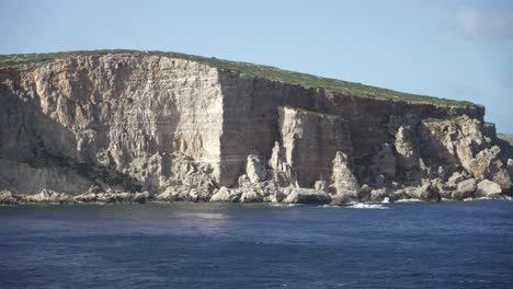 steep limestone island shore in mediterranean sea near malta