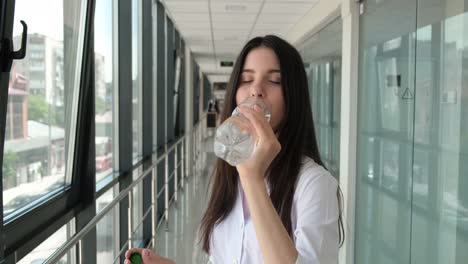 girl doctor drinks mineral water in the hospital