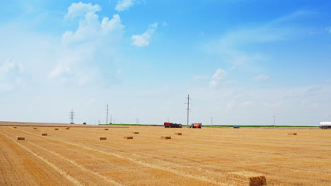 hay bales in a field under a sunny sky