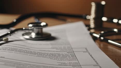 medical bill and stethoscope on a desk