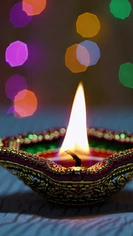 close-up of a lit decorative lamp with colorful bokeh in the background, captured from a low angle