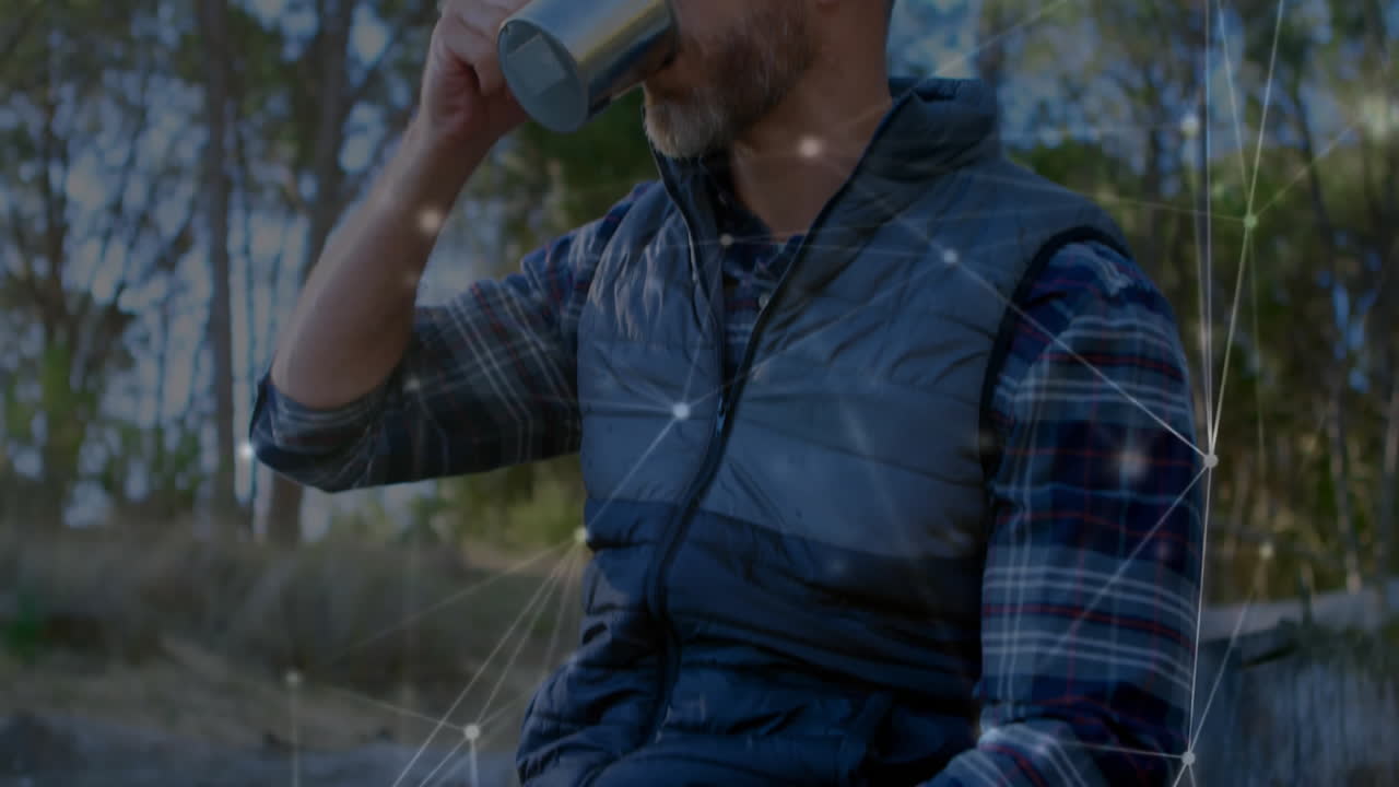 Man drinking from metal cup outdoors, showcasing network technology lines and nodes overlay