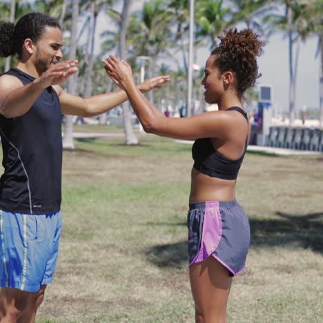 Athletic-couple-warming-up-in-park