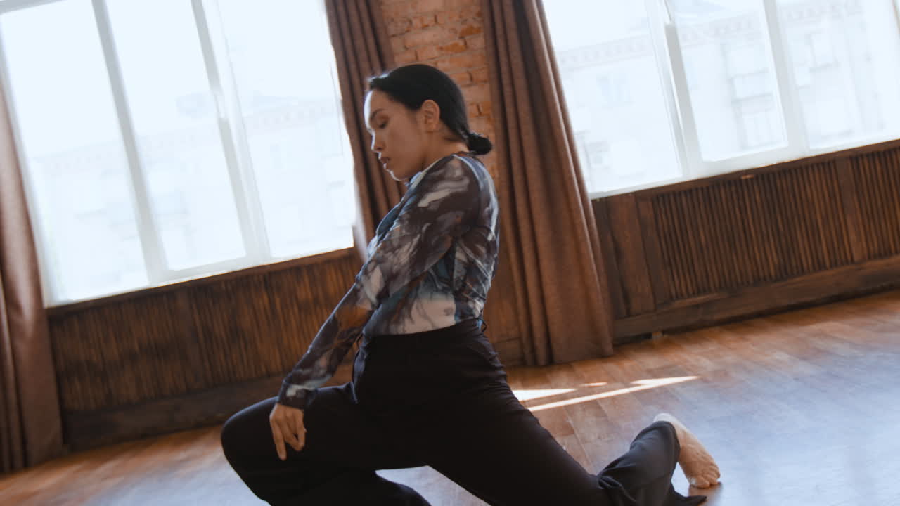 Expressive Contemporary Dance Movements by a Female Dancer in a Bright Studio