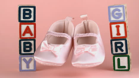 Baby-shoes-falling-between-baby-blocks