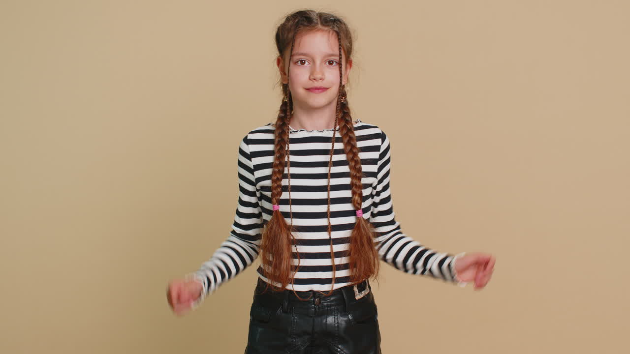 Happy child girl kid listening music dancing disco having fun relaxing on party making funny moves