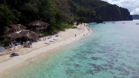 tropical beachfront thatch bungalows of vellago resort on seven commandos beach in el nido