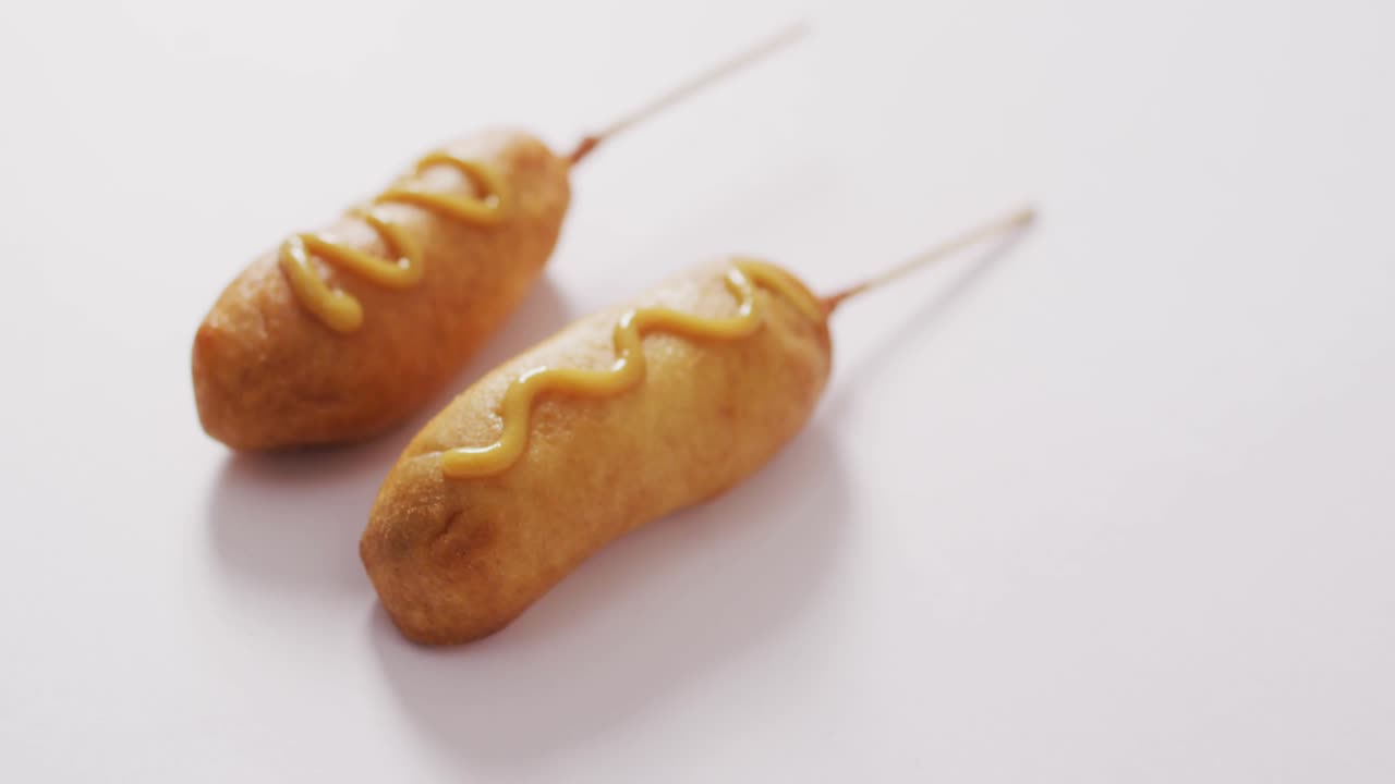 Network fading above mustard-drizzled corn dogs starting bar sweeping upward updating year labels