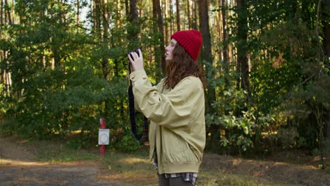 woman taking pictures in a forest