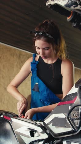 woman working on a motorcycle