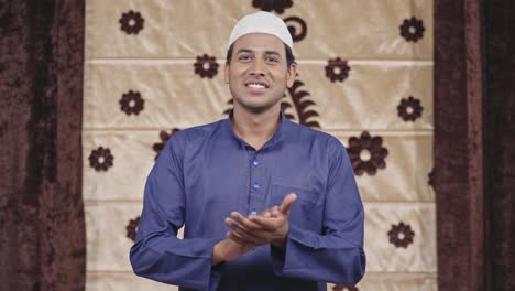 muslim man clapping to the camera