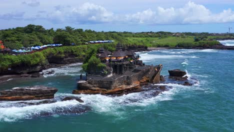 ancient hinduism temple tanah lot in bali, indonesia - aerial shot