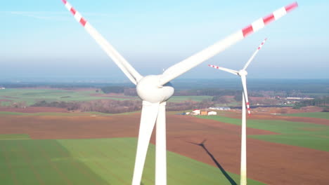 Aerial-orbiting-view-of-a-wind-farm-in-rural-autumn-landscape-during-cloudy-day-outdoors-in-nature