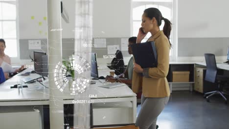 Animation-of-data-processing-and-globe-over-biracial-businesswoman-talking-on-smartphone-in-office