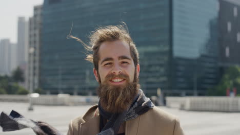 portrait professional young hipster man smiling enjoying successful urban lifestyle happy bearded entrepreneur in sunny outdoors city slow motion