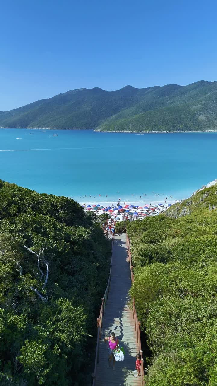Beautiful Beach with Clear Blue Water and Crowds of People
