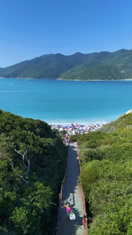 beautiful beach with clear blue water and crowds of people