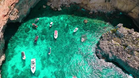 drone aerial video showcasing boats anchored in the stunning turquoise waters of crystal lagoon, malta