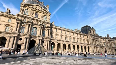 visitors exploring the louvre museum courtyard