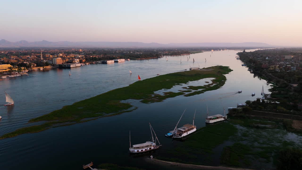 Felucca navigating waters of Nile with passengers