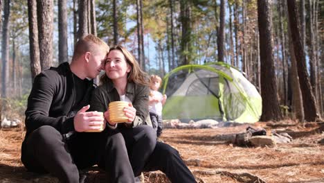a Couple Joyfully Shares a Moment over Coffee at a Serene Forest Campsite Capturing Love a Couple Joyfully Shares a Moment over Coffee at a Serene Forest Campsite Capturing Love and Adventure