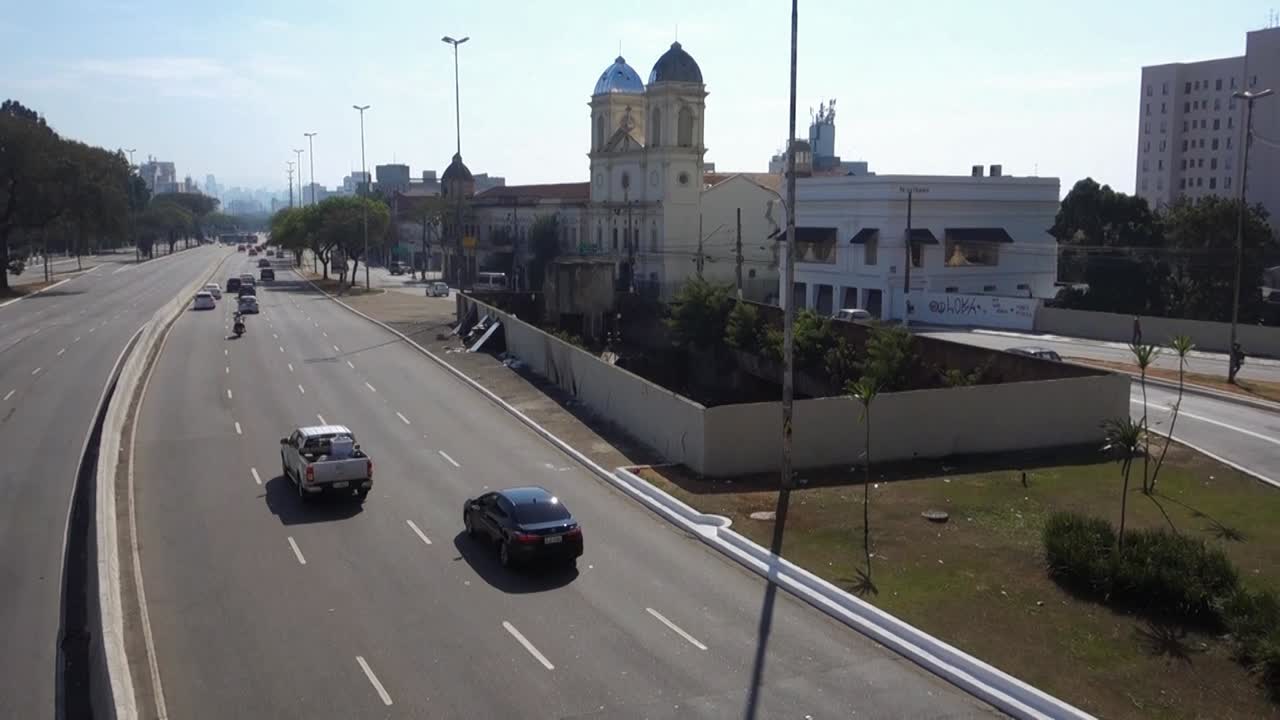 high angle of Tiradentes avenue in Sao Paulo, Brazil. The State Pinacoteca and the Luz station are on the left