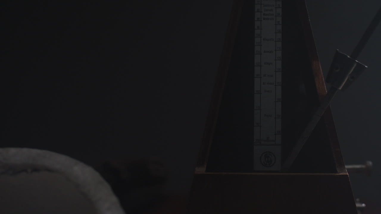 Metronome set the rythm in the dark, old room