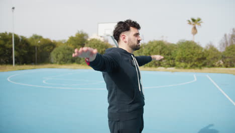 man stretching on a basketball court