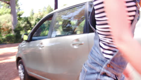 four friends getting out of a car and unpacking it